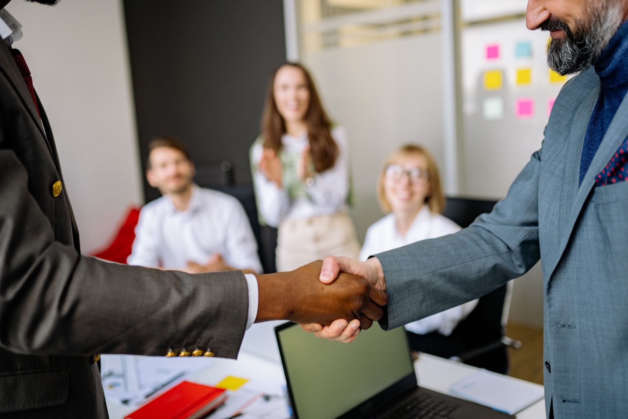 Close up shot of 2 person shake hands on UCSTAK's How It Works page.