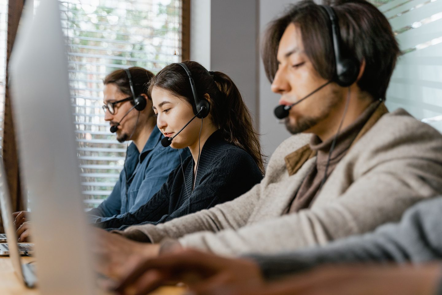 People Working As Call Center Agents People working as call center agents on UCSTAK's Managed Contact Center page.