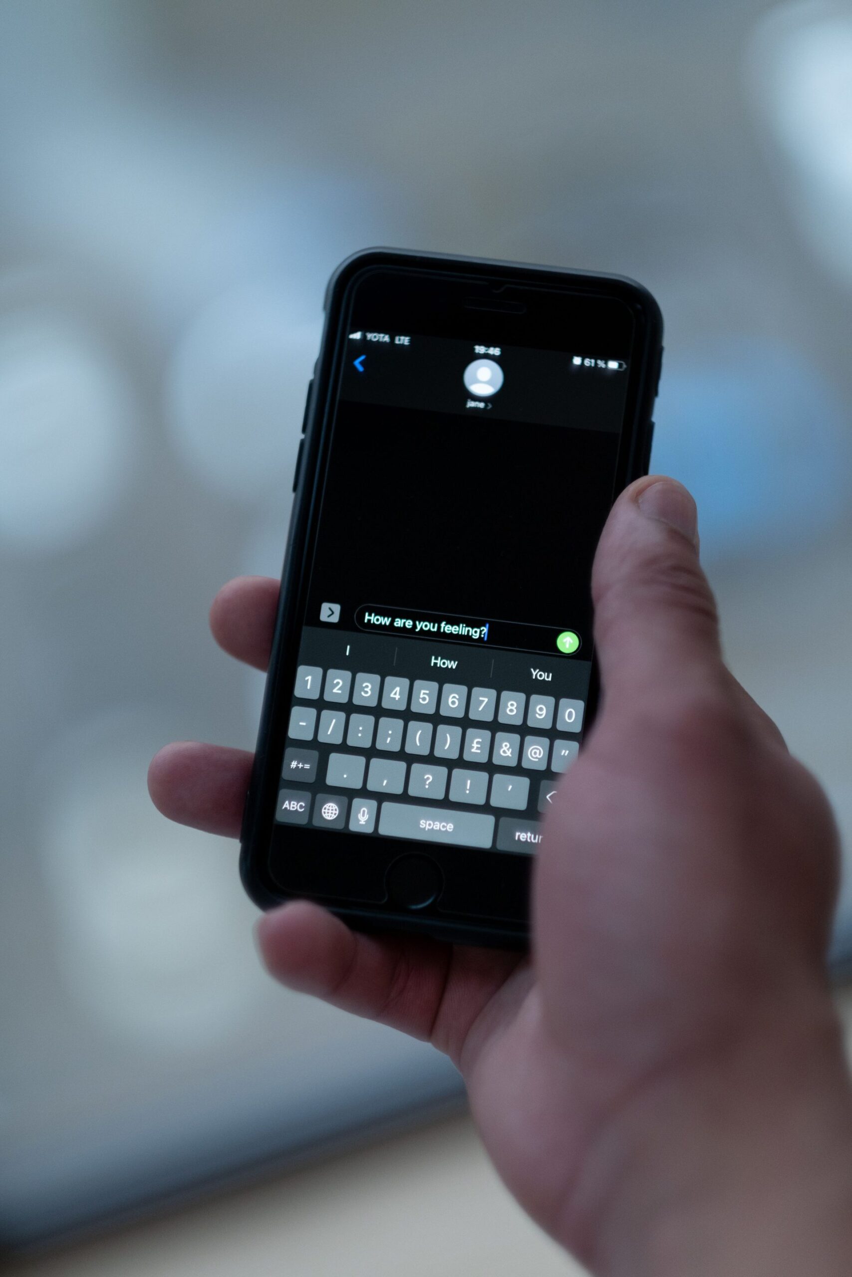 Smart phone in a hand, representing UCSTAK's Omnichannel Messaging feature.