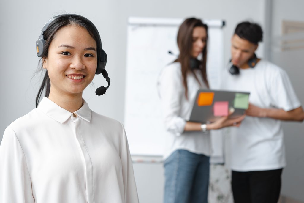 Woman Wearing a Headset Woman wearing a headset, representing UCSTAK's Website Live Chat feature.