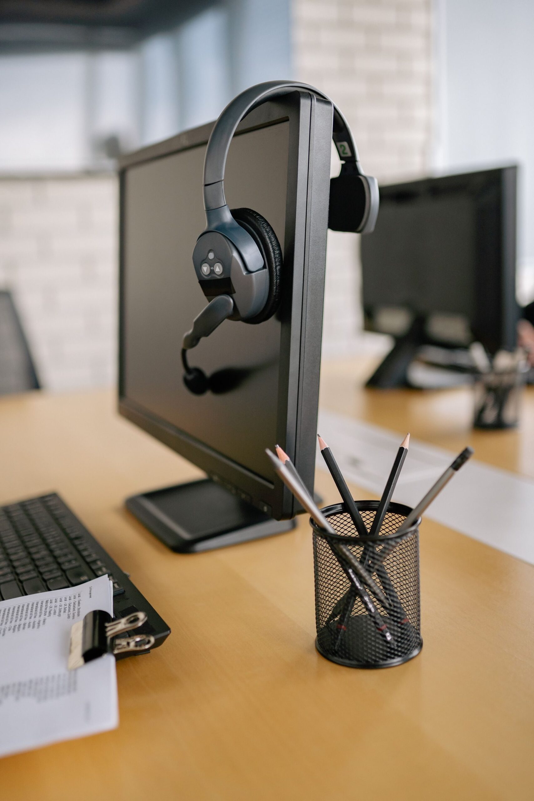 Headphones on a Monitor Headphones on a monitor, representing UCSTAK's Agentless Dialer feature.