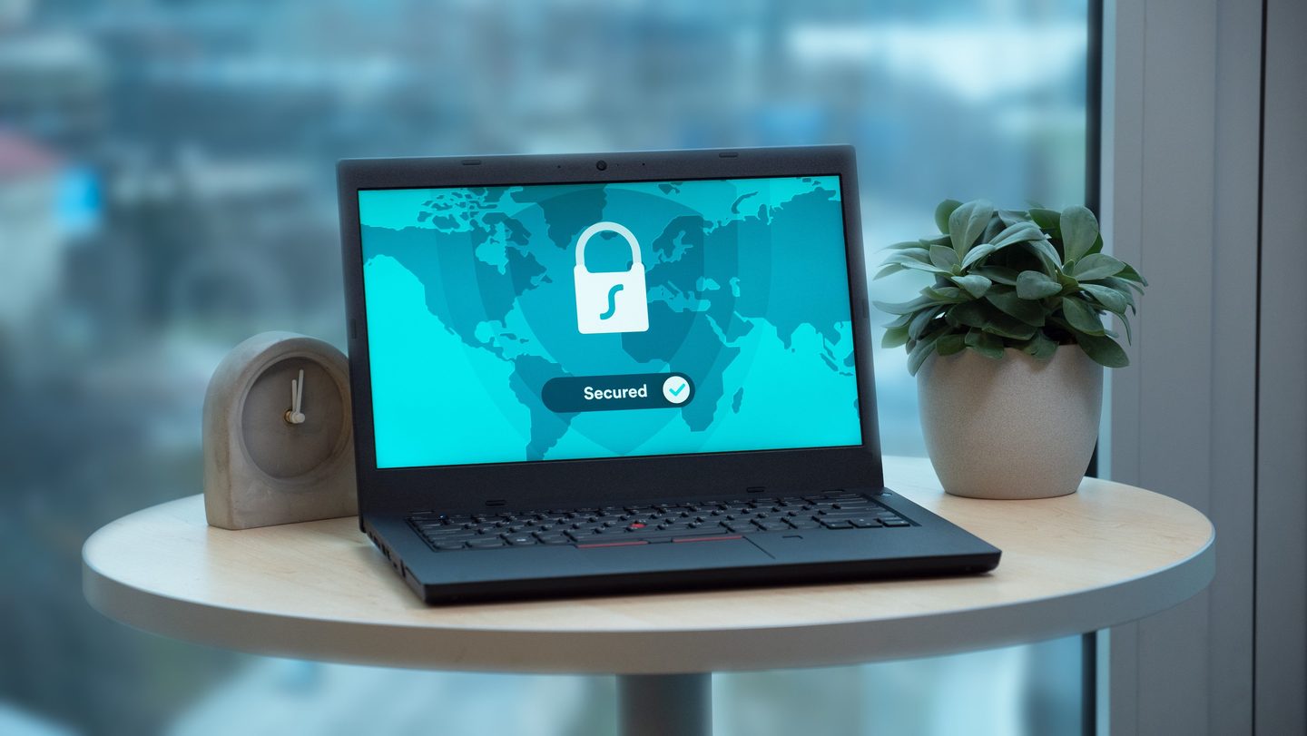 A laptop over a round table, representing UCSTAK's Call Recording Retention & Access Controls feature.