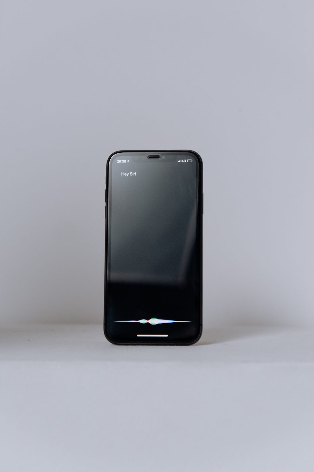 Black samsung android smartphone on white table, representing UCSTAK's AI Receptionist feature.