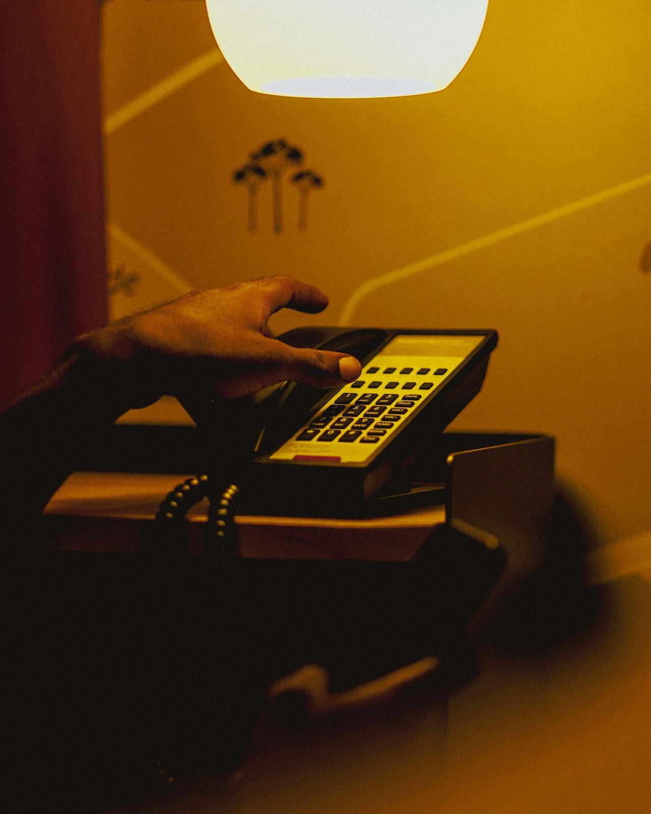 Retro Handset Phone with Yellow Glow Retro handset phone with yellow glow in room, representing UCSTAK's Call Transfer & Parking feature.