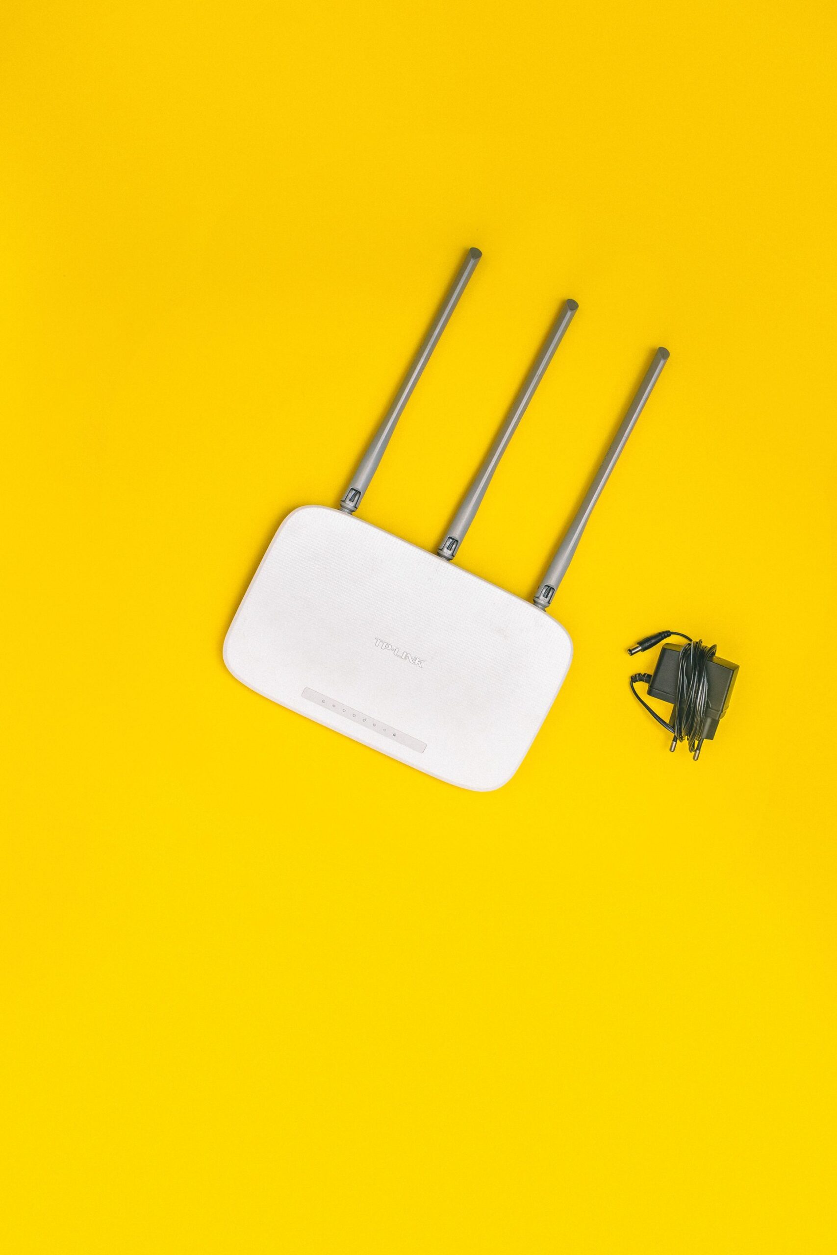 Wifi Router on Yellow Background Wifi router on yellow background, representing UCSTAK's Connecting Analog Devices (Fax Machines, Alarm Panels, Older Phones) feature.