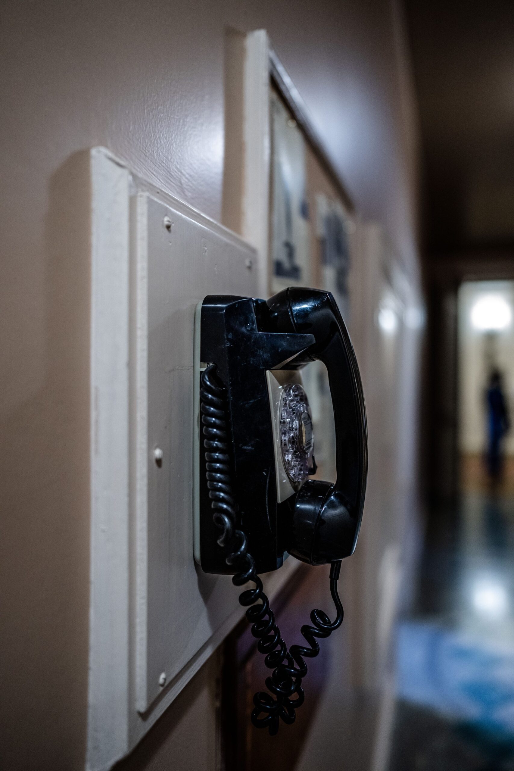 Telephone Handset on Wall at Night Telephone handset on wall at night, representing UCSTAK's Common-Area & Guest Phones feature.