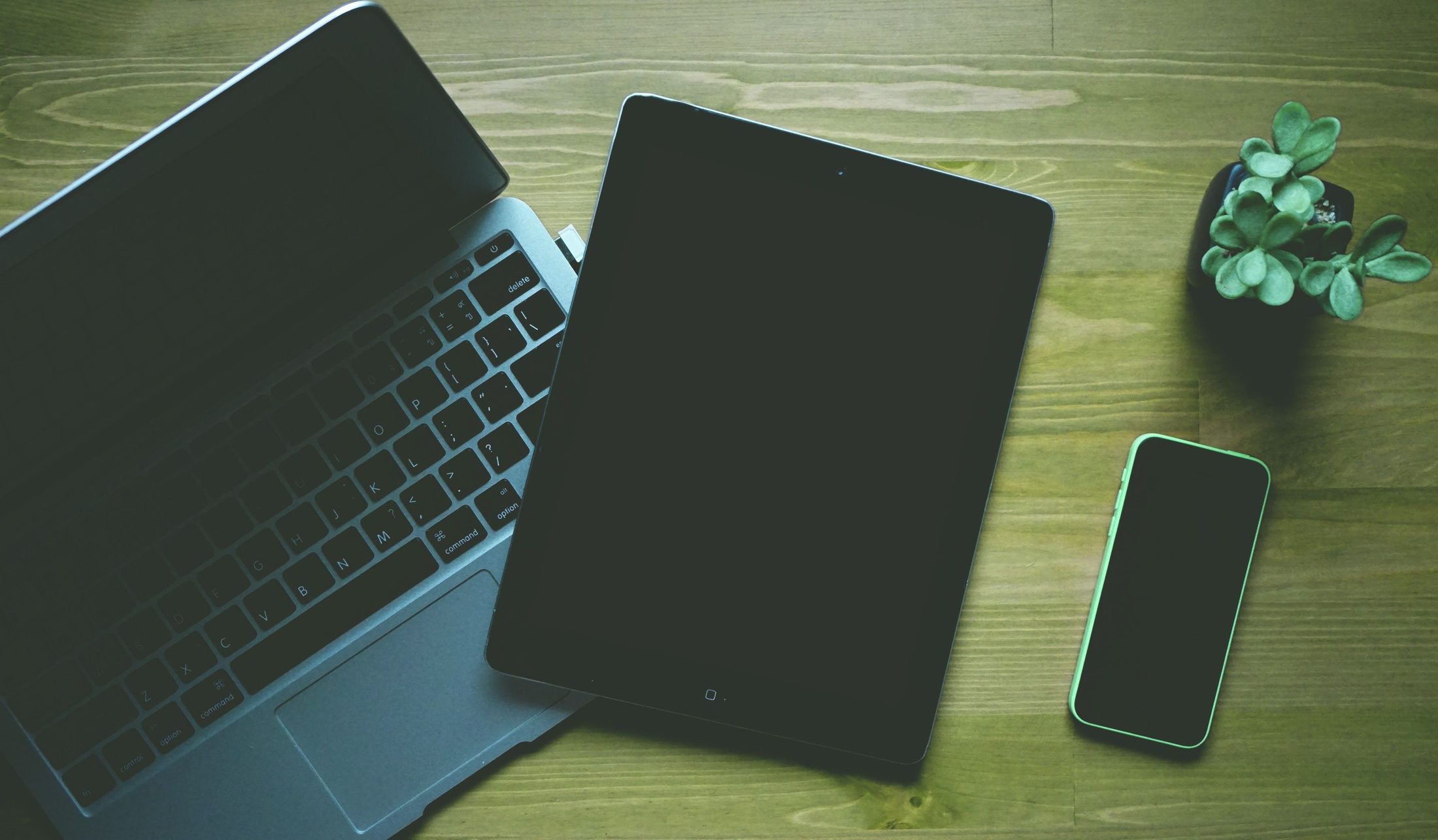 Black Ipad Beside Green Iphone 5c Black ipad beside green iphone 5c, representing UCSTAK's Presence & Status Sync Across Devices feature.