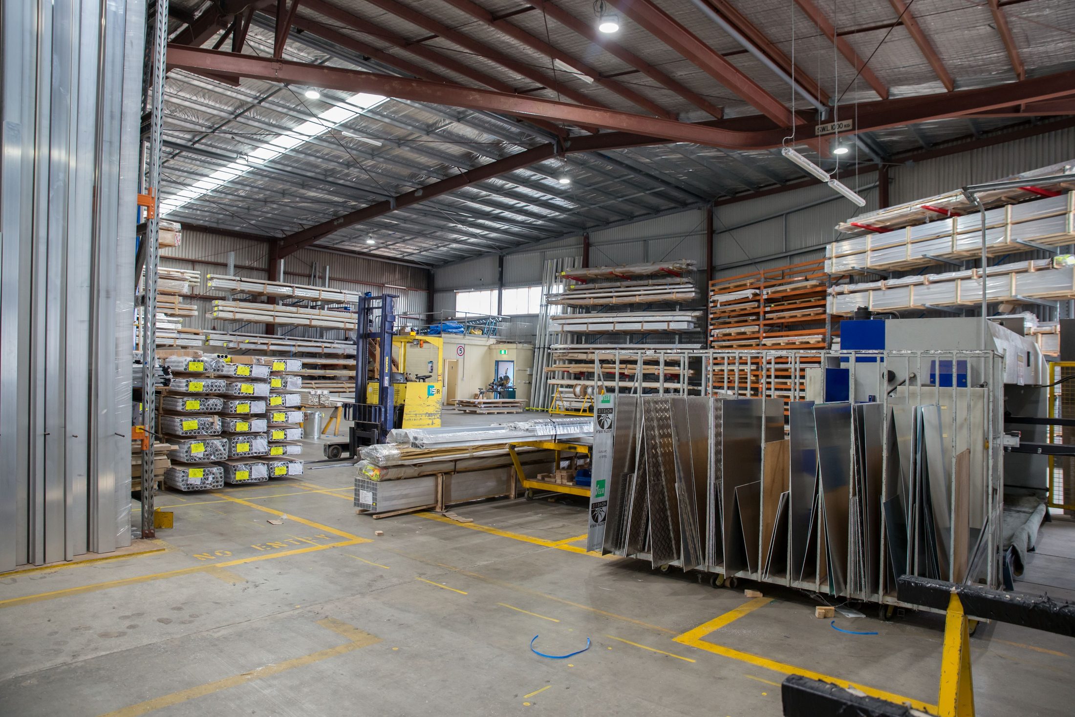 Spacious Industrial Warehouse Interior with Storage Spacious industrial warehouse interior with storage racks, representing UCSTAK's One-Way Paging feature.