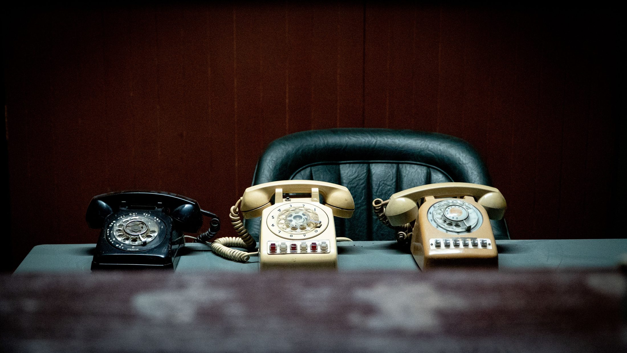 Vintage Rotary Phones on Retro Office Vintage rotary phones on retro office desk, representing UCSTAK's Two-Way Intercom feature.