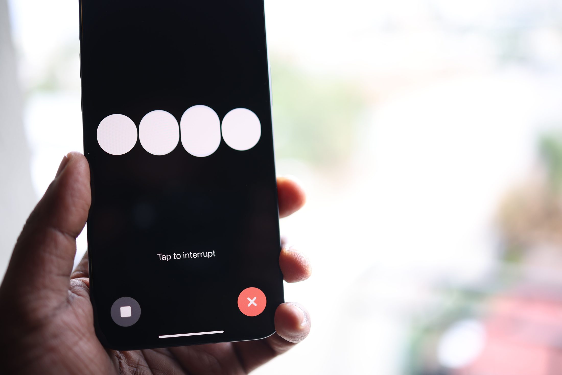 A hand holding a smartphone, representing UCSTAK's Press 0 Escape from Voicemail feature.