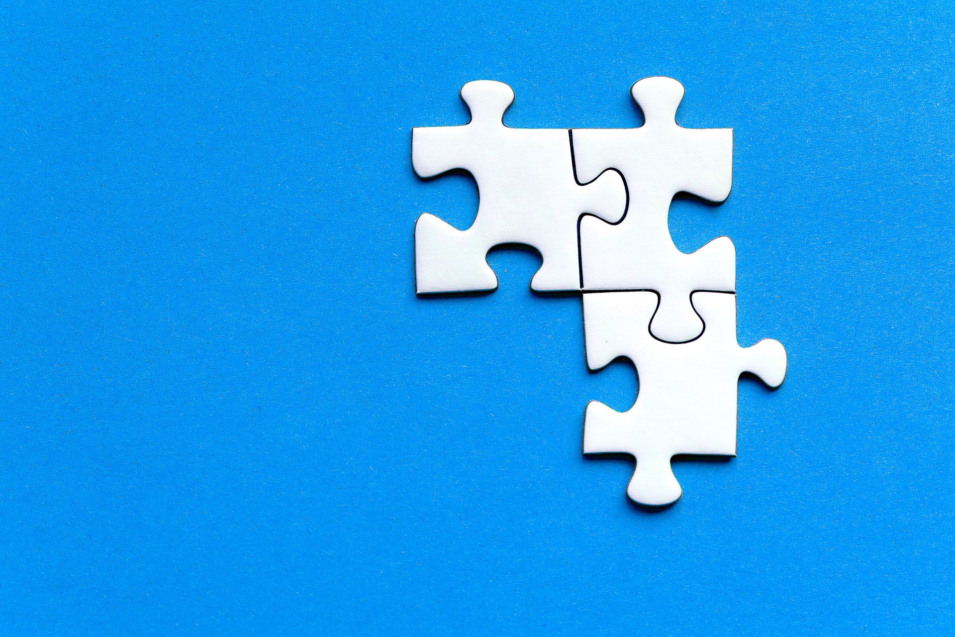 Puzzle pieces on blue surface, representing UCSTAK's Integrations feature.