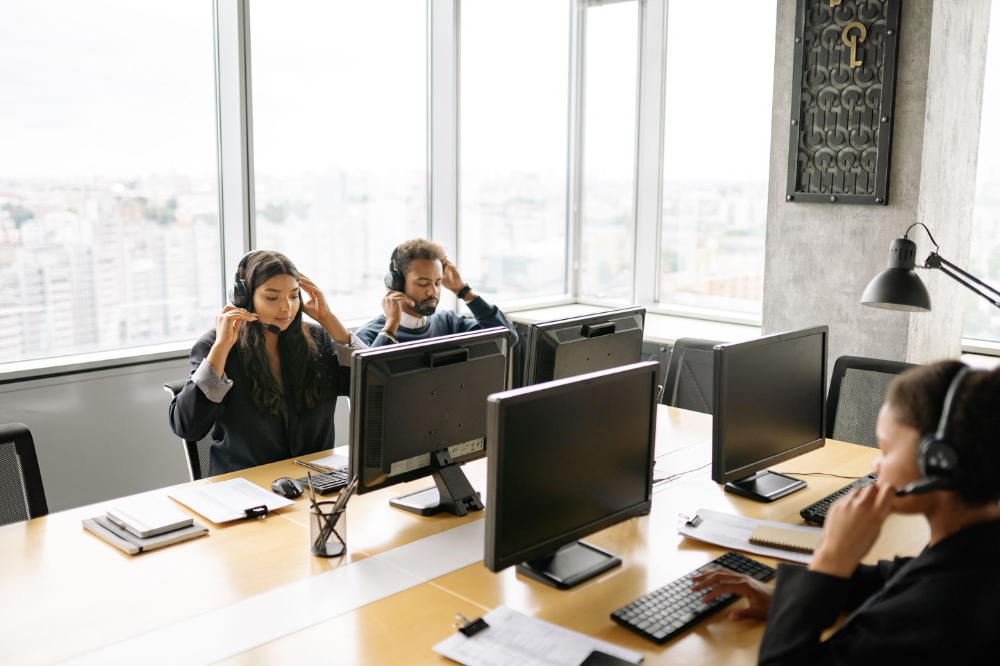 Call Center Agents Working at an Call center agents working at an office, representing UCSTAK's Helpdesk Integrations feature.
