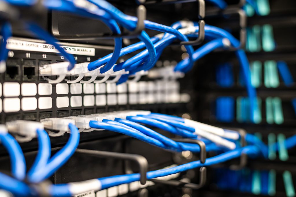 Blue Wires Connected to Server Blue wires connected to server, representing UCSTAK's Structured Cabling & On-Site Network Installation feature.