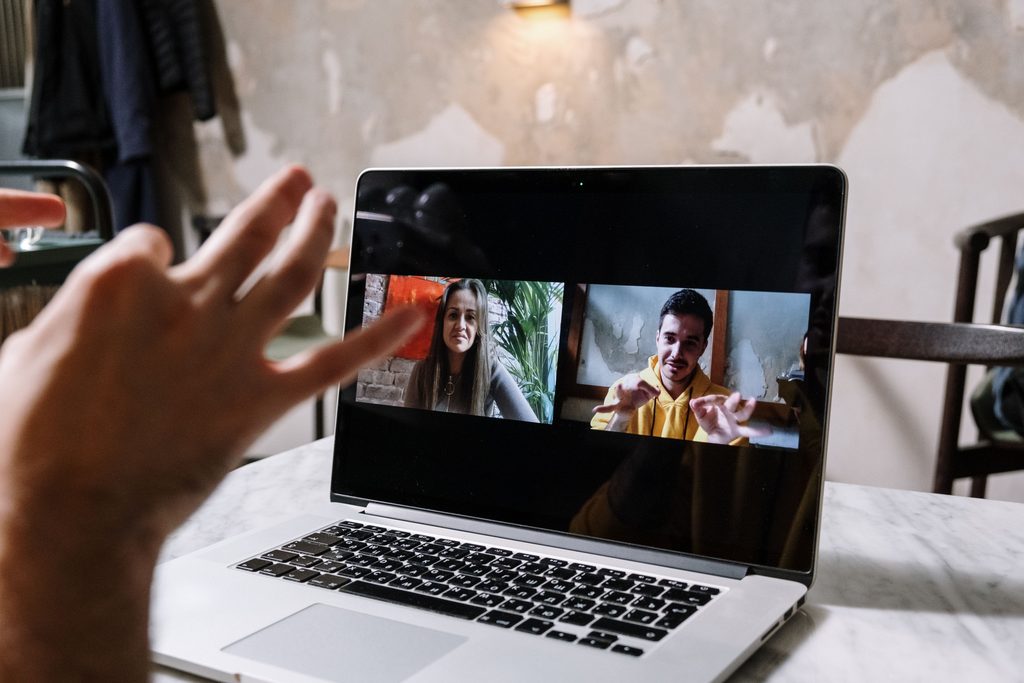 Man and woman video call on laptop on UCSTAK's Team Collaboration & Unified Communications page.