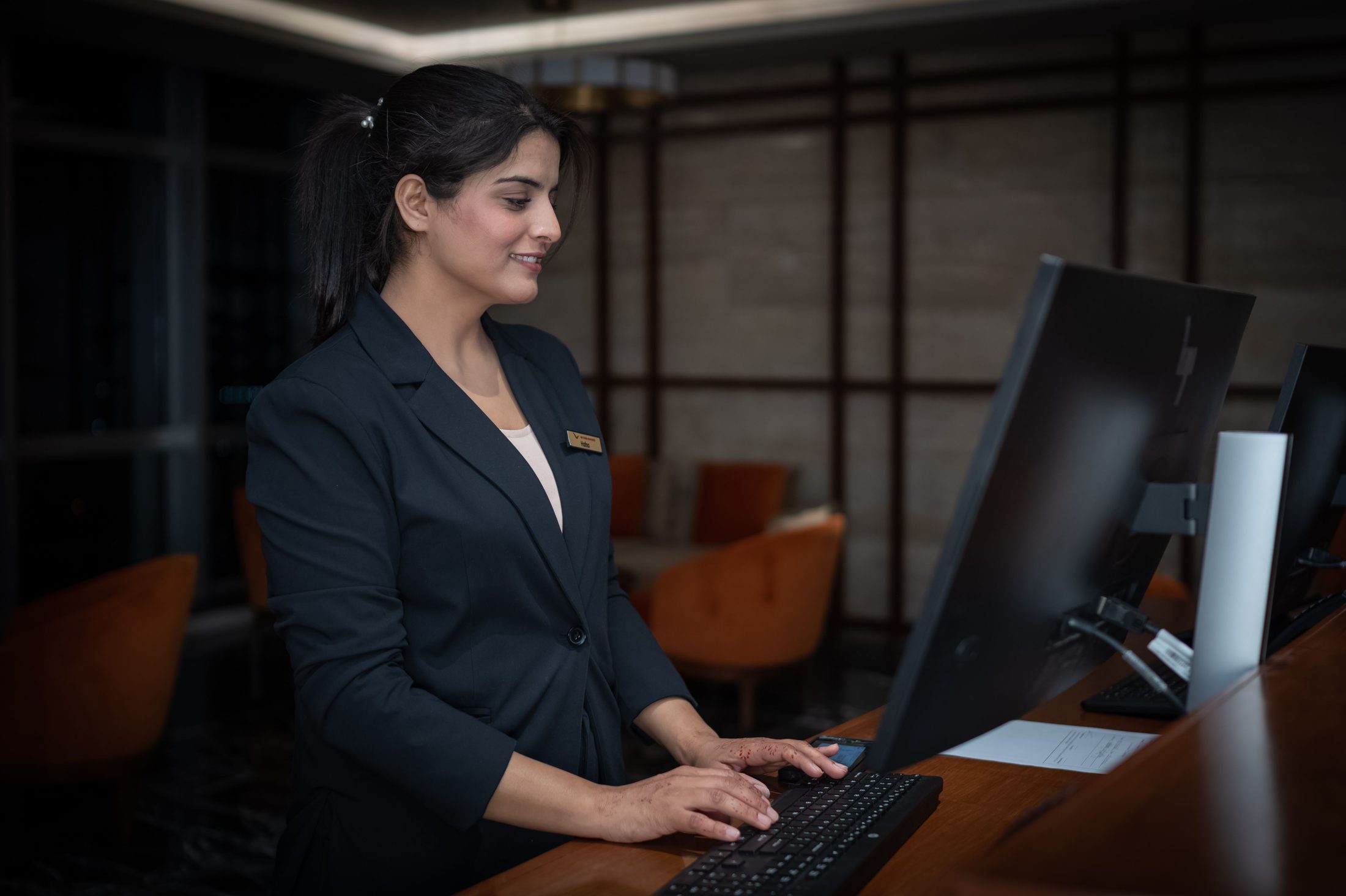 Professional Receptionist at Work in Islamabad Professional receptionist at work in islamabad hotel, representing UCSTAK's Operator Panel (Receptionist Console) feature.