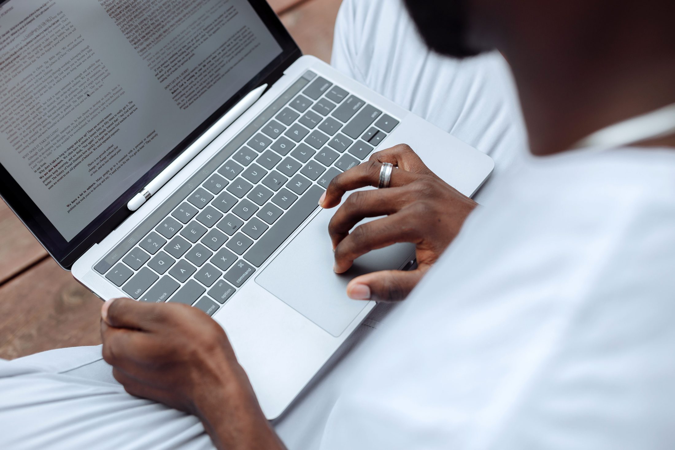 A Person Browsing the Documents on A person browsing the documents on a laptop, representing UCSTAK's Text-to-Speech Voice Prompts feature.