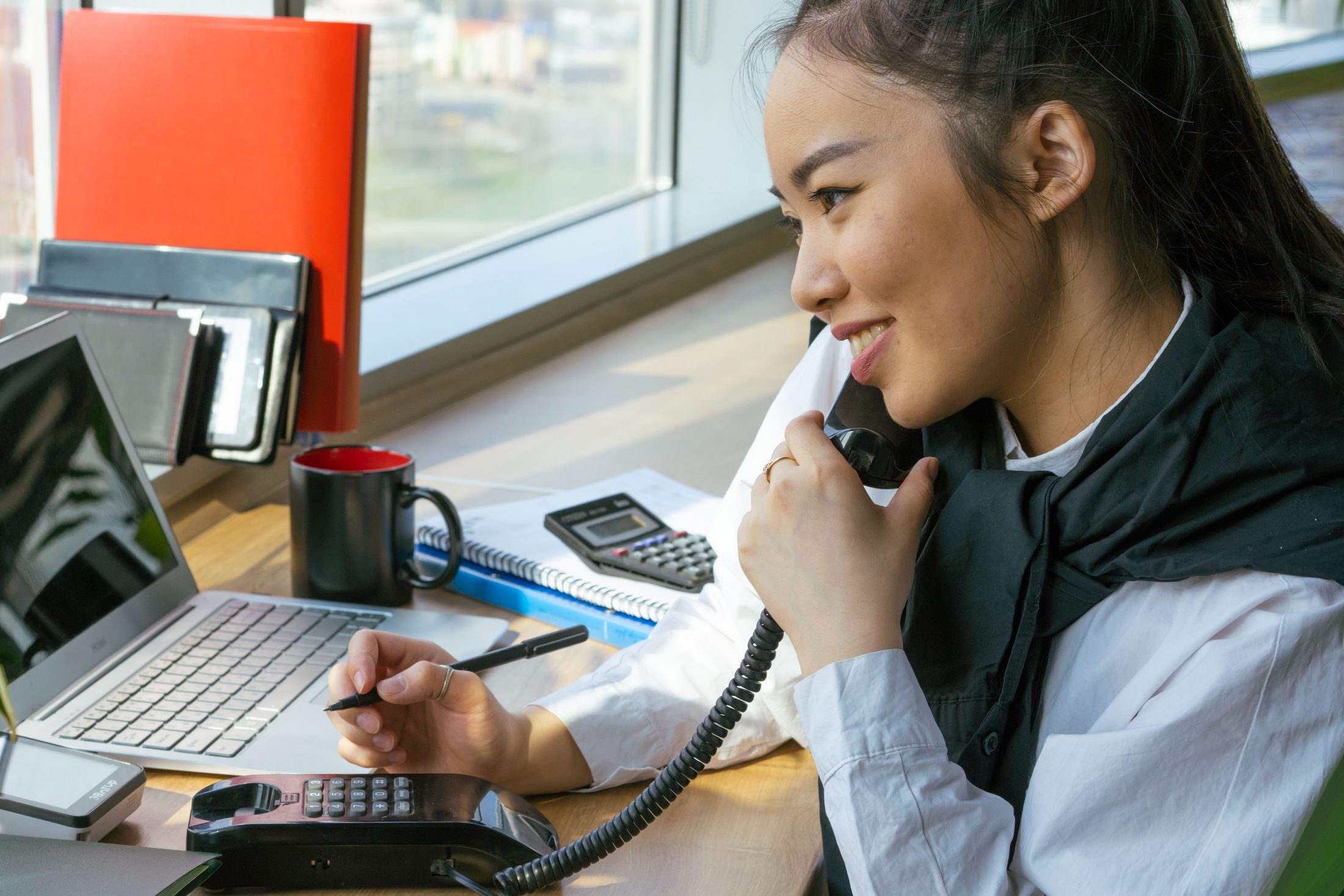 A woman talking on the phone on UCSTAK's Education page.