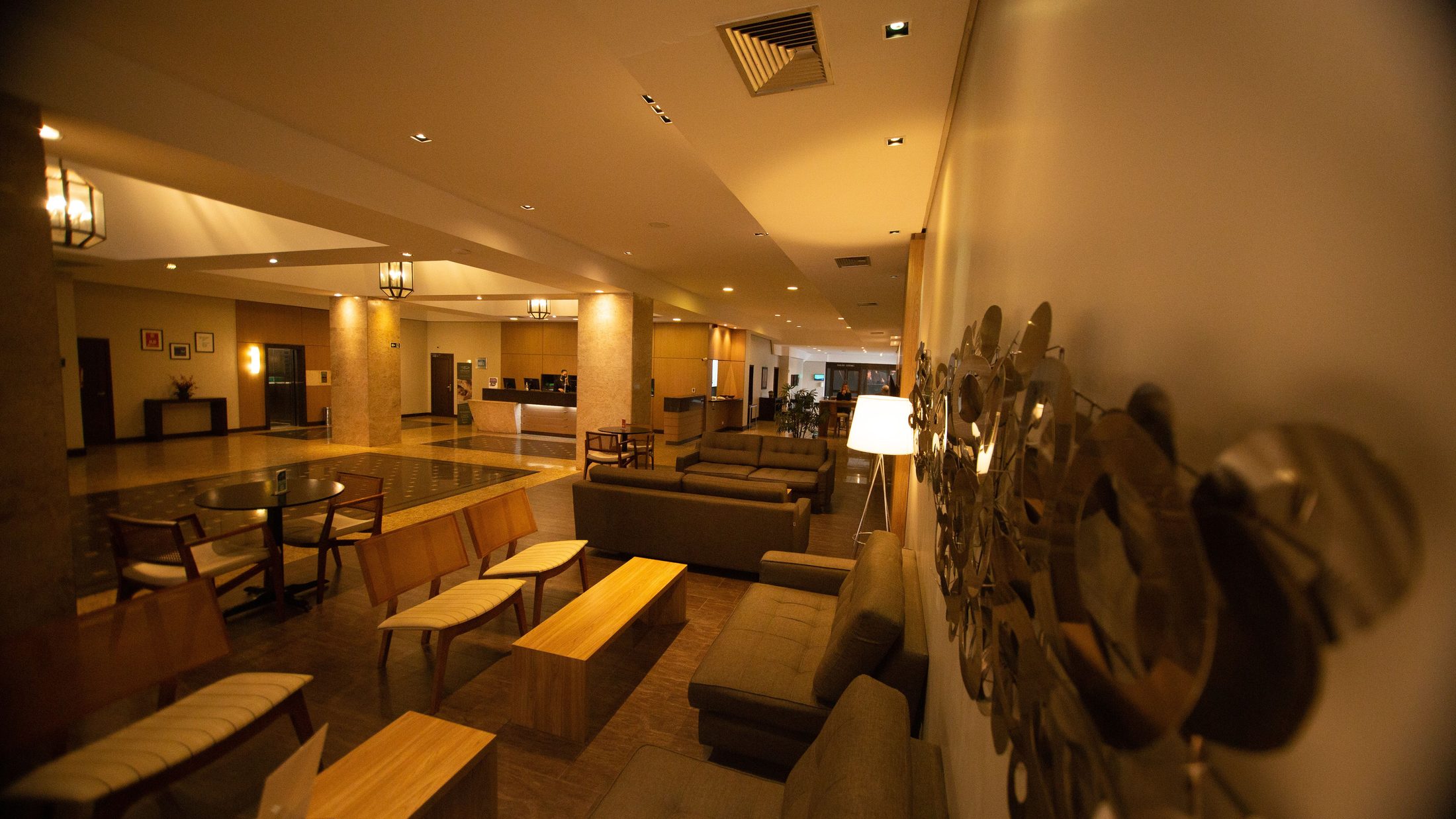 Wide angle shot of a hotel hall with sofas and chairs on UCSTAK's Hospitality page.