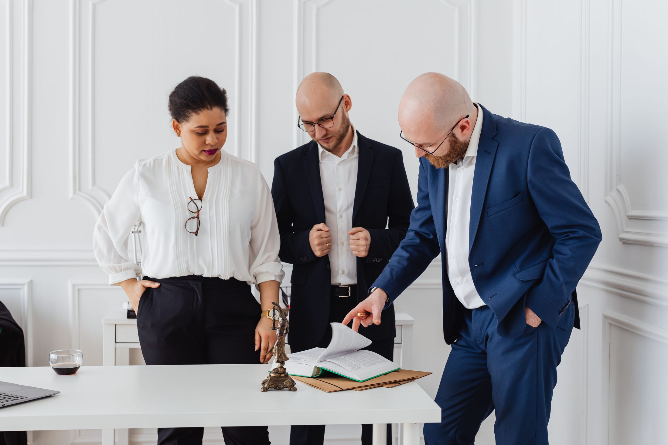 People in the office looking at a document while standing on UCSTAK's Legal page.