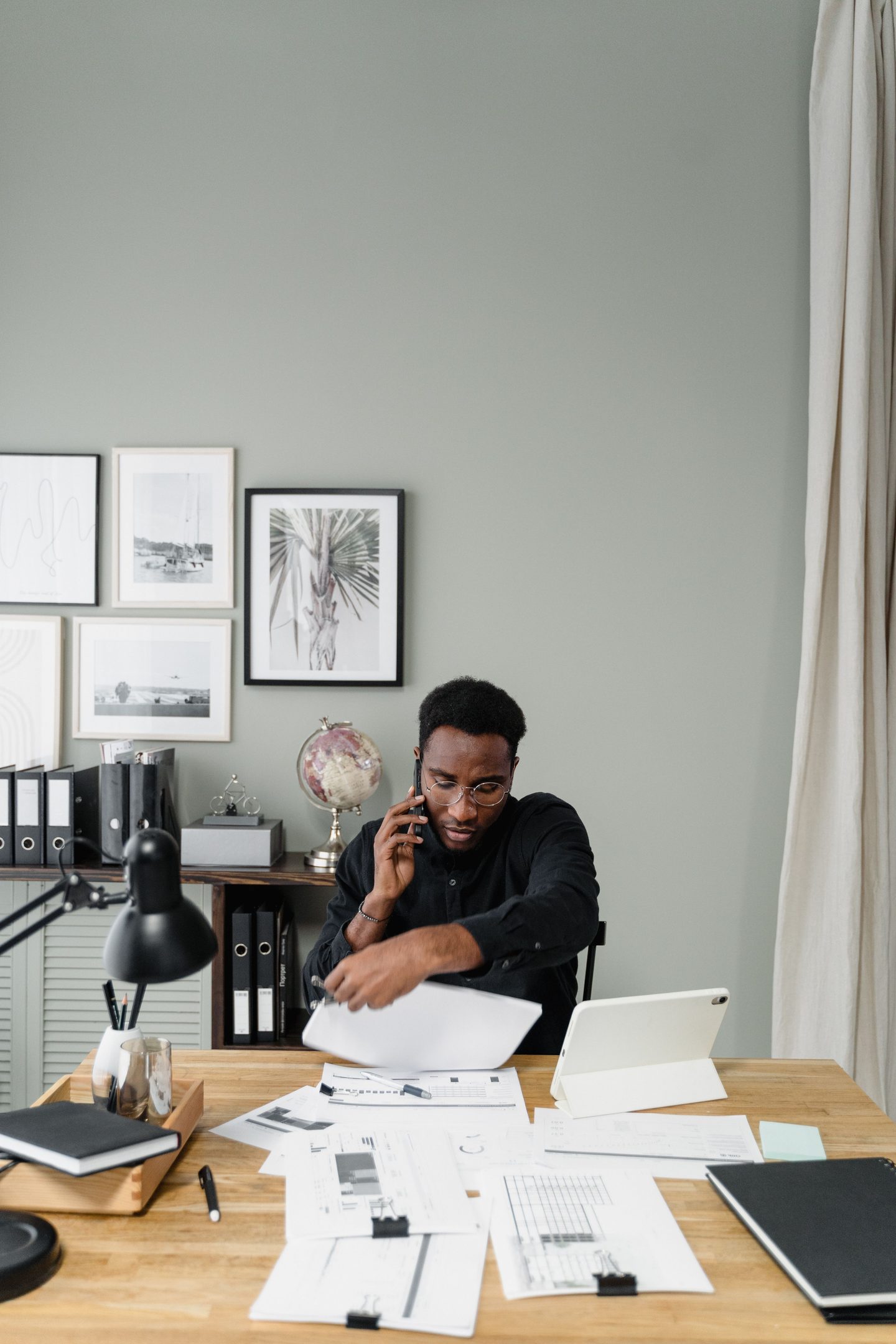 A man sitting at the table while talking on the phone on UCSTAK's Accounting Firm page.