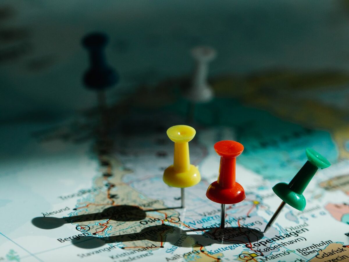 Colorful map pins marking multiple locations on a map, representing UCSTAK's regional and multi-country availability.