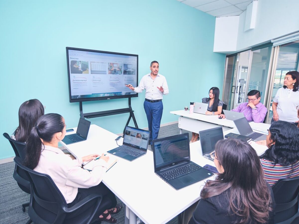 A presenter leading a staff training session in a conference room, representing UCSTAK's staff training and onboarding process.